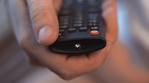 Man's hand with remote control includes TV Stock Footage 69836258