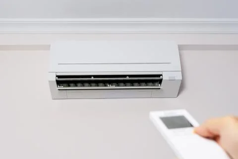 Man's hand with remote control turning on the air conditioner. Stock Illustration