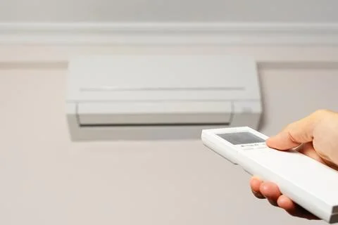 Man's hand with remote control turning off the air conditioner. Stock Illustration