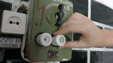 Man's hand replaced outdated ceramic fuse on old switchboard. Stock Footage 100447032