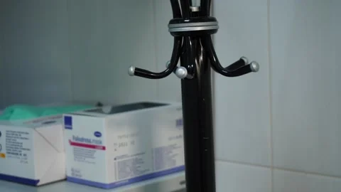  man’s hand with a ring on his finger hangs a white robe on a hook Stock-Footage 130649077