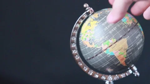 Man's hand rotates the globe Stock Footage 85187909