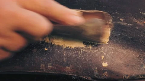 A man's hand rubs excess putty on a car wing with sandpaper 库存影片 209593761