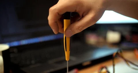 Man's hand with a screwdriver on laptom bacground Stock Footage 102382903