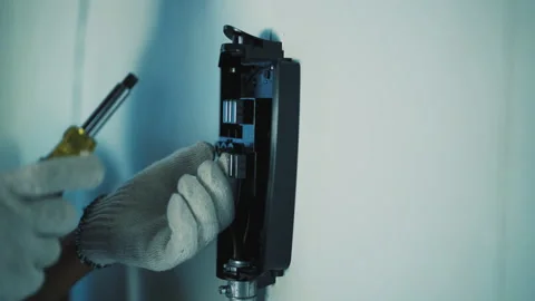 A Man's Hand Screwing the Charging Base Stock Footage 199128539