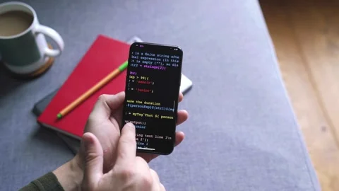 Man’s Hand Scrolling and  JavaScript Computer Code on a Modern Smartphone Stock Footage 318367875
