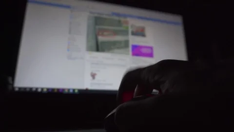 Man's hand scrolling a computer mouse in front of desktop screen in a dark room Stock Footage 107153634