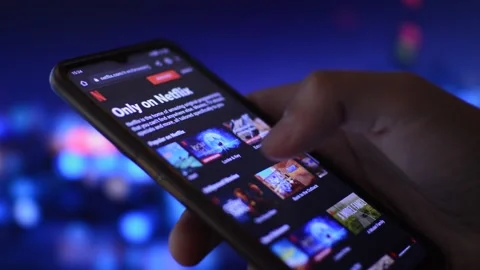 Man's hand scrolling netflix streaming app library. film streaming on netflix Stock Footage 204796389