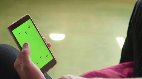 Man's hand scrolling smartphone with green screen Stock Footage 80904091