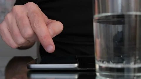 Man's hand scrolling up on a smartphone. Slow motion. Stock Footage 146010627