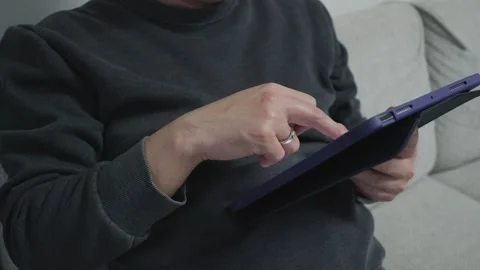 Man's hand scrolling, tapping on tablet/ipad Stock Footage 259968860