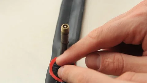 A man's hand seals a patch on a bicycle patch Stock Footage 270800488