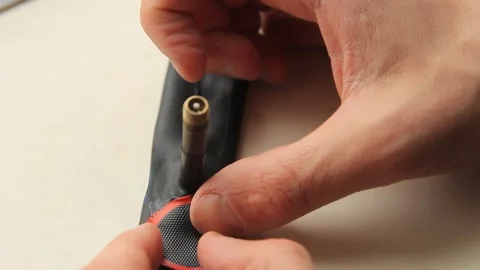 A man's hand seals a patch on a bicycle patch Stock Footage 270800593