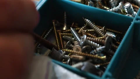 Man's hand searching for a screw in a plastic organizer box Stock Footage 325833881