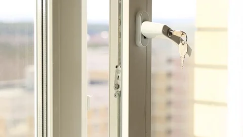 Man's hand on secure window handle Stock Footage