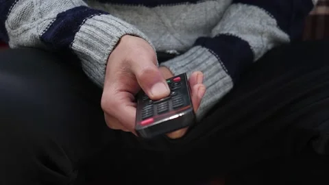 Man's hand selects internet tv channels with remote Vidéo 145197958