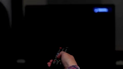 Man's hand selects internet tv channels with remote control, close-up. Stock Footage 257873467