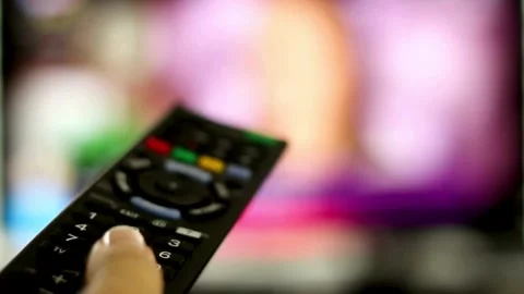 Man's hand selects internet tv channels with remote control, close-up. Stock Footage 257873469