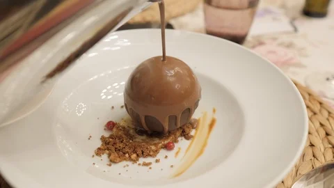 Man's hand serving a chocolate dessert with ice cream in restaurant Stockbeeldmateriaal 116113150