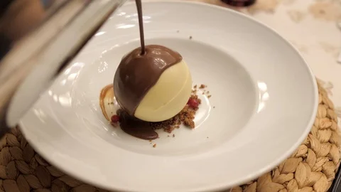 Man's hand serving a chocolate dessert with ice cream in restaurant Stockbeeldmateriaal 116113239