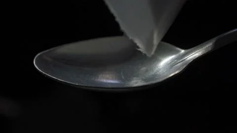 Man's hand sets fire the lighter over spoon of boiling drug, diluted heroin Stock Footage 98744759