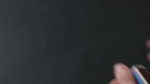 Man's hand sets fire to a match from a box Stock Footage 145536978