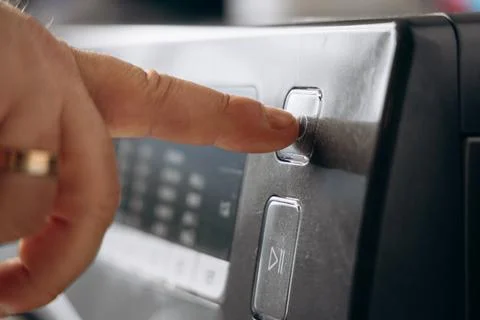 A man's hand sets a washing program. Start washing. Finger pressing button .. 스톡 사진