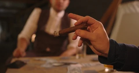Mans hand shakes off the ashes of cigar Stock Footage 117675534