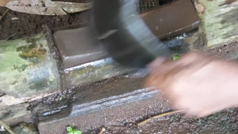 A mans hand sharpening a machete on a sharpening stone Stock Footage 312095556