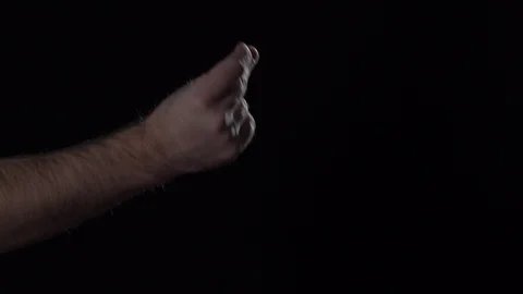 Man's hand shows finger multiple clapping gesture on black background. Stock Footage 124846898