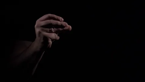 Man's hand shows finger multiple clapping gesture on black background. Video stock 124950863