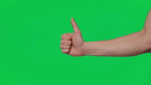 Man's hand shows gestures and signs of success on a chroma key green screen Stock Footage 231774579
