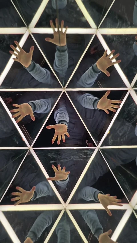A Man's hand shows a gestures in a mirror kaleidoscopic reflection. Abstract Stock Footage 281002087