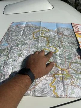 Man's hand with smartwatch, pointing at a map of the Basque country with a Stock Photos