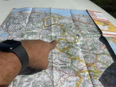 Man's hand with smartwatch, pointing at a map of the Basque country with a Stock Photos