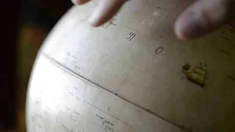 Man's hand spin a sphere earth globe map planisphere. world globe map man Stock Footage 197511947