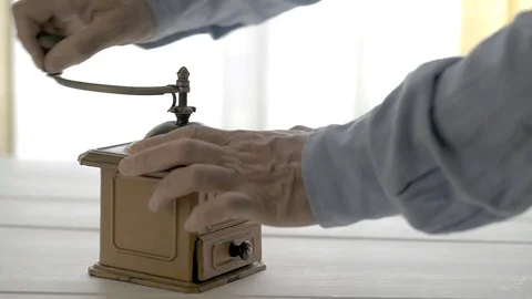 A man's hand spinning an old coffee grinder Stock Footage 77558644