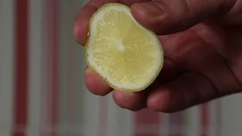 A man's hand squeezes lemon into a salad close up Stock Footage 324766670