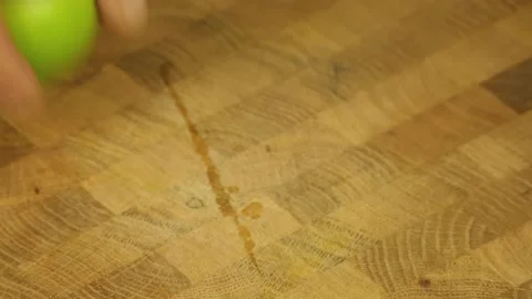 Man's hand squeezes lime juice Stock Footage 189971312