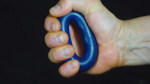 Man's hand squeezes a round rubber expander. close-up. Stock Footage 100405993