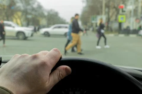 Man's hand on the steering wheel of the car Stock Photos