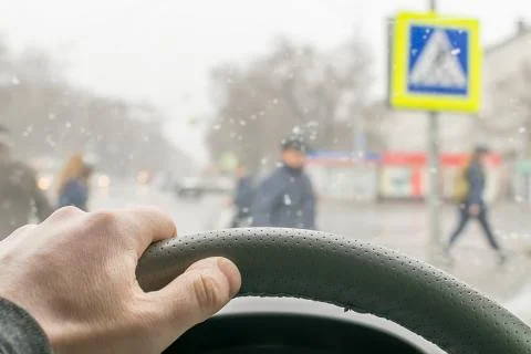 Man's hand on the steering wheel of the car Stock Photos