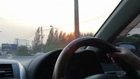 Man's hand on steering wheel, driving a car at sunset. road trip at sunset. Stock-Footage 336265864