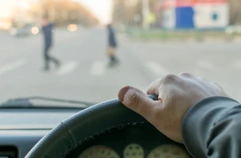 Man's hand on the steering wheel Stock Photos