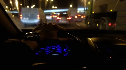 Man's hand on the steering wheel, view from inside the car on the night road Stock Footage 171071622