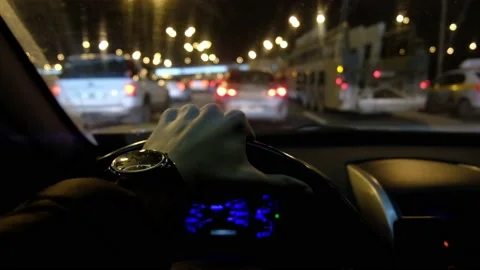 Man's hand on the steering wheel, view from inside the car on the night road Stock Footage 171071941