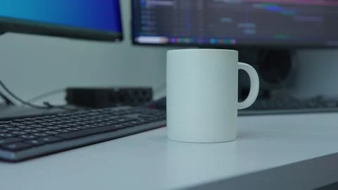A man's hand stirring a liquid with a spoon in a white mug. Stock Footage 274176517