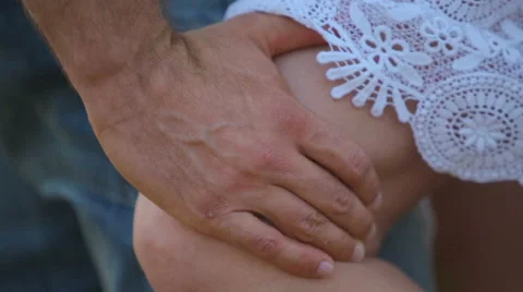 Man's hand stroking woman's leg. Men's sexy women's fingers on his knee. Stock Footage 54772854