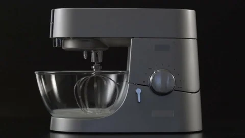 Man's hand switch on a kitchen stand mixer with glass bowl Stock Footage 76642633