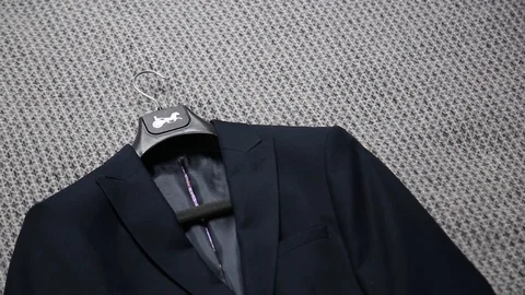 Mans hand take jacket laying on a bed. Stock Footage 108560674